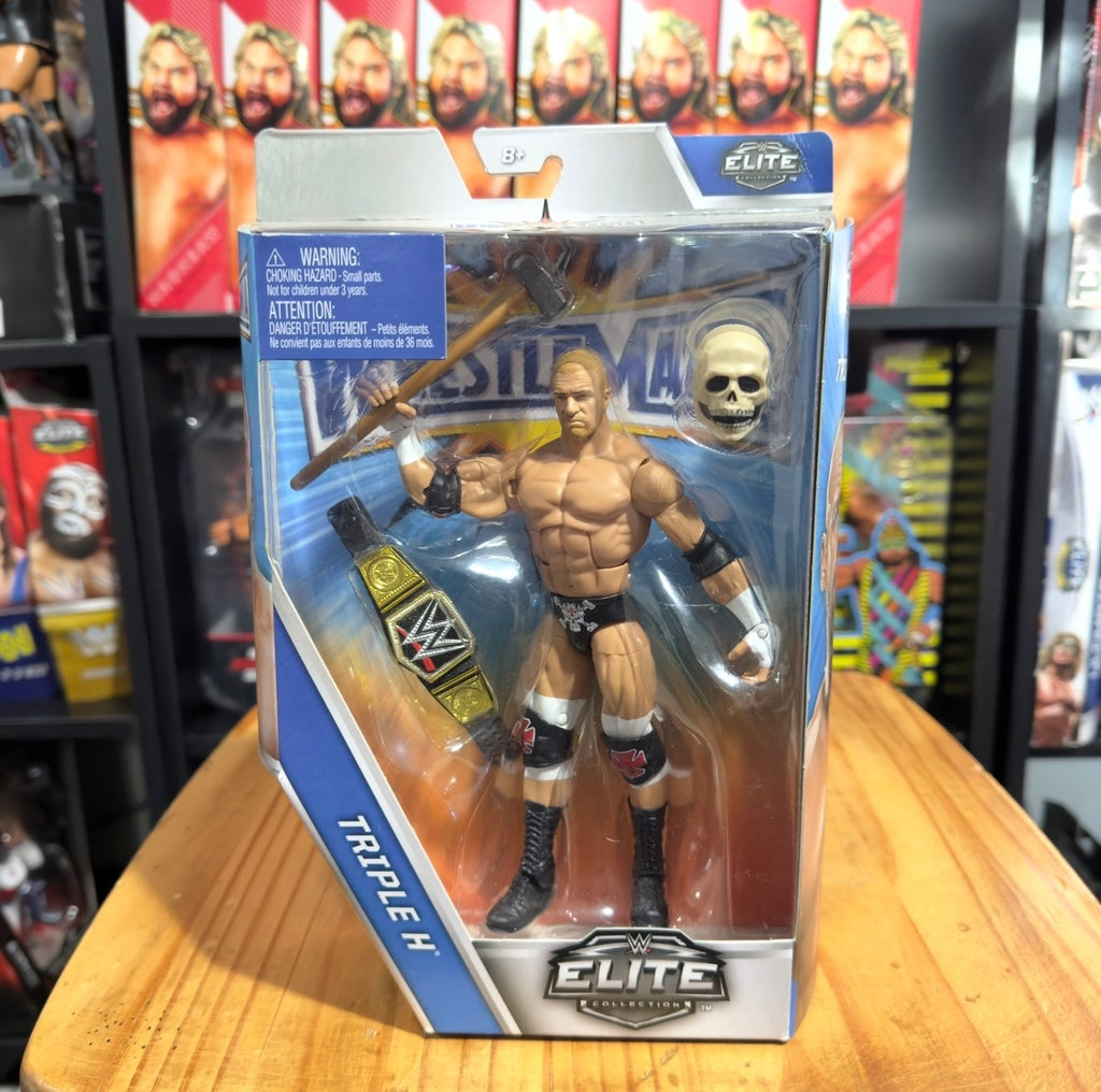Elite action figure box: Triple H in blue packaging, bare chest and black wristbands