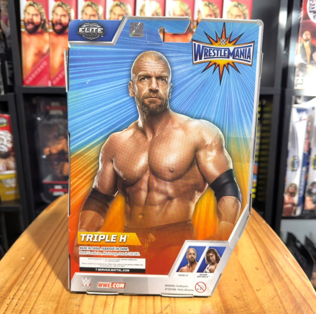 WrestleMania Elite action figure box showing Triple H bare-chested with black wristbands