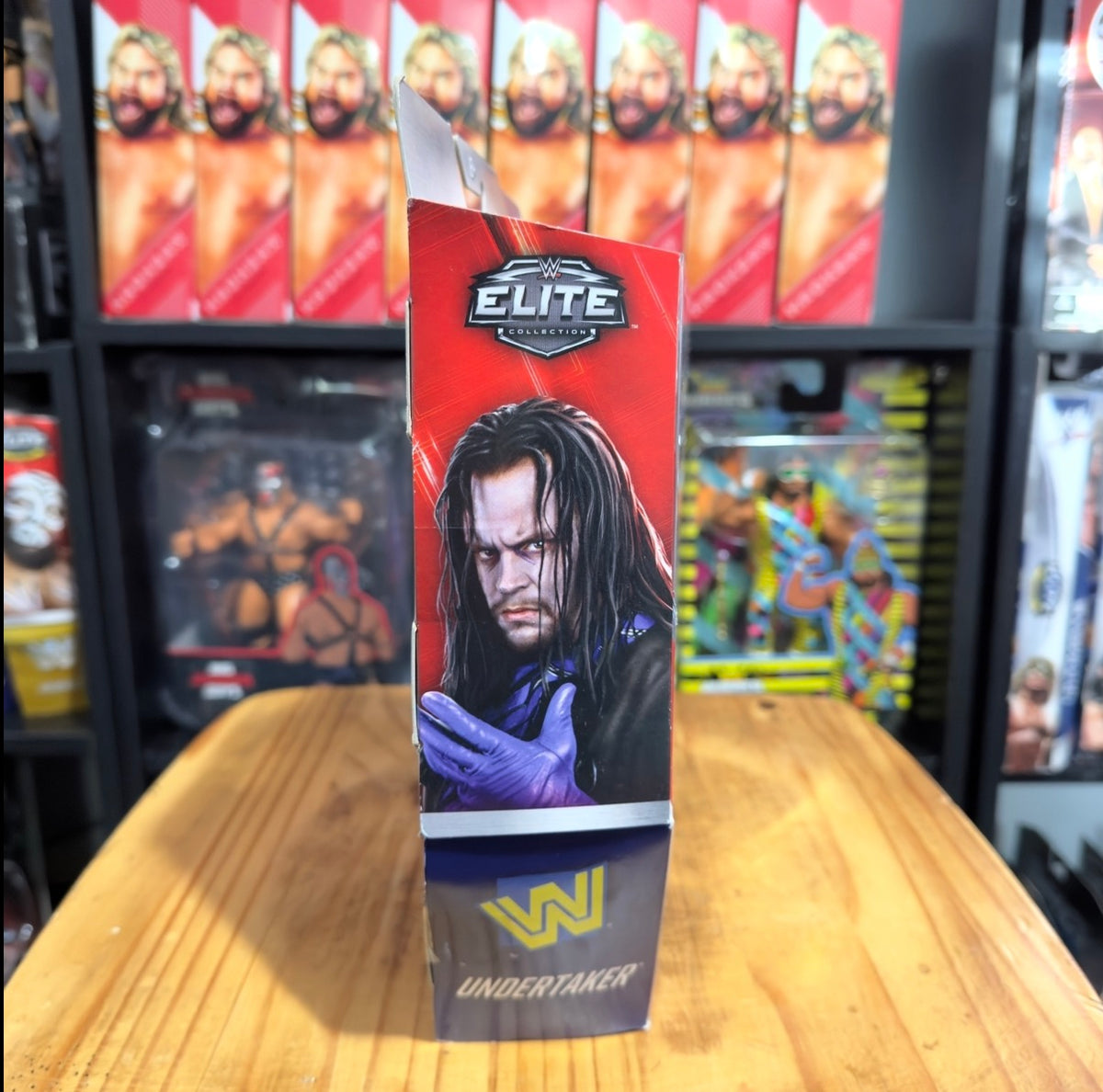 Undertaker WWE Elite boxed action figure with black coat and purple-gloved hands