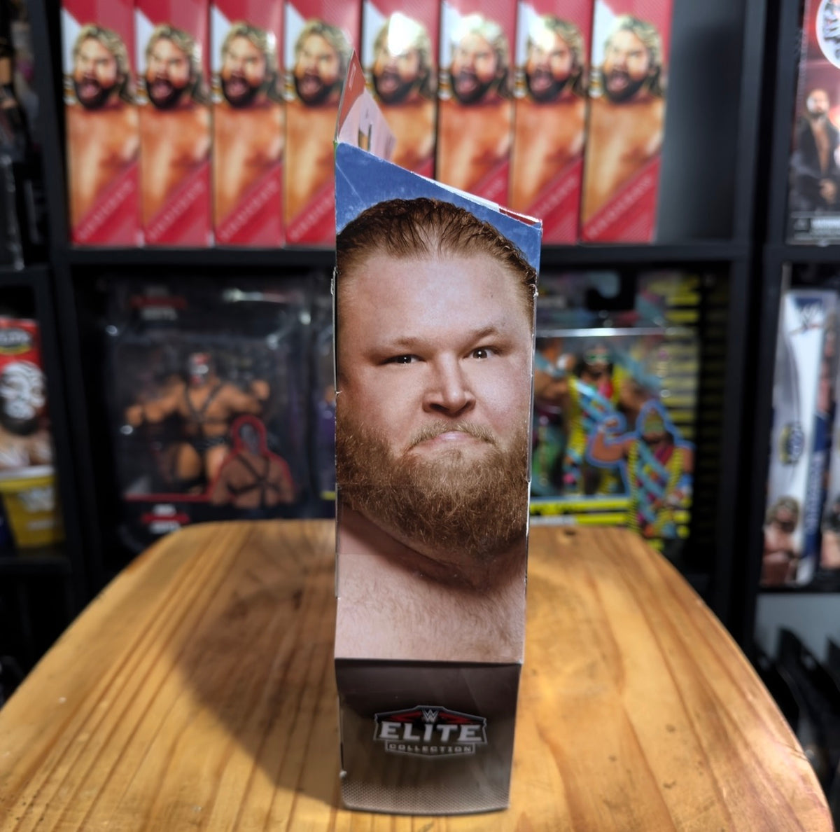 WWE Elite Collection action figure box, close-up bearded face and Elite logo