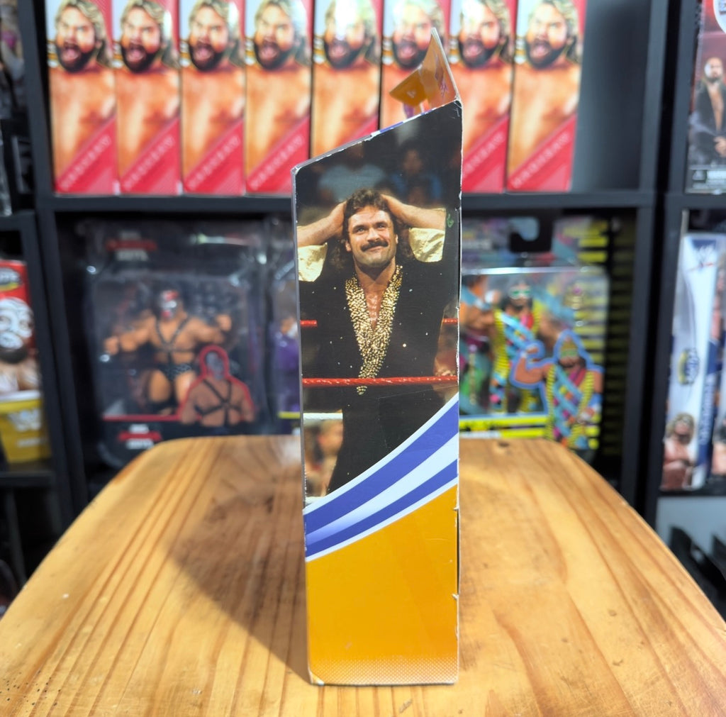 WWE Elite figure packaging side panel with Rick Rude wearing a gold jacket