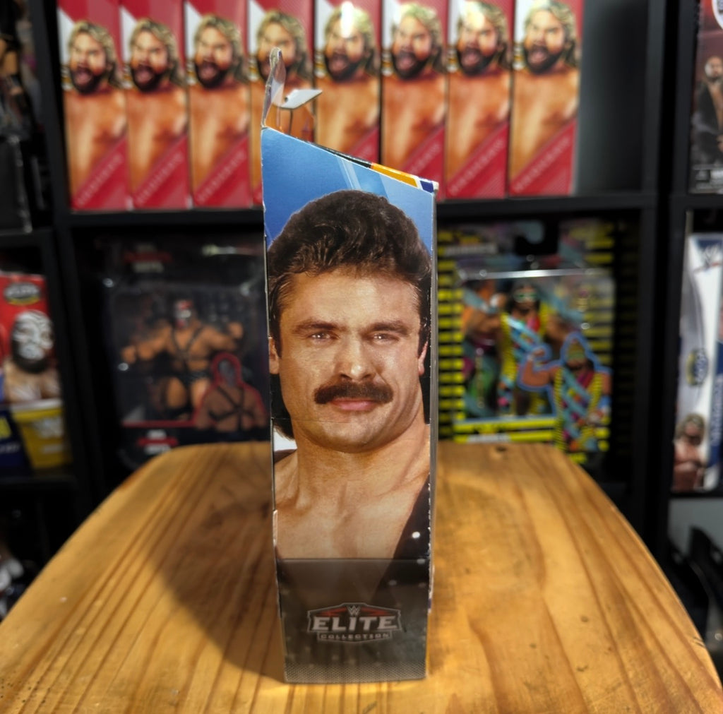 WWE Elite figure box with Rick Rude portrait window, gold jacket detail visible