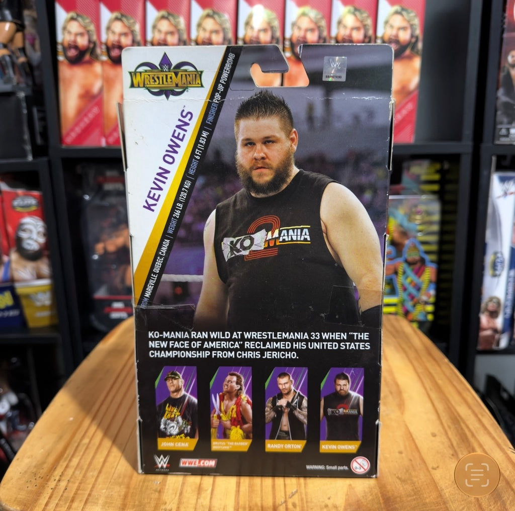 Kevin Owens action figure box back panel with wrestler photo and accessory images