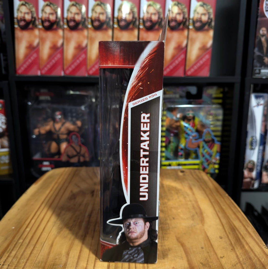 WWE Undertaker action figure in tall boxed packaging, dark red and black branding