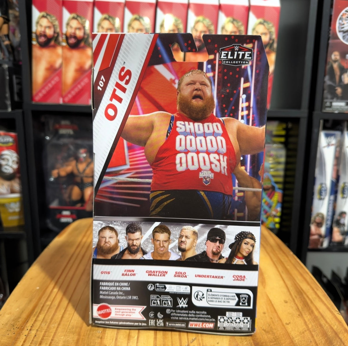 Otis action figure in Elite box, front view with wrestler art and product back panel