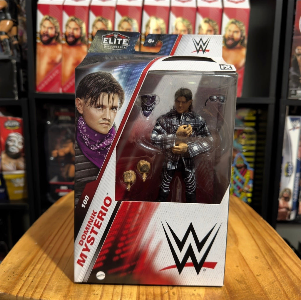 Boxed WWE action figure in clear window, checkered shirt and purple scarf visible