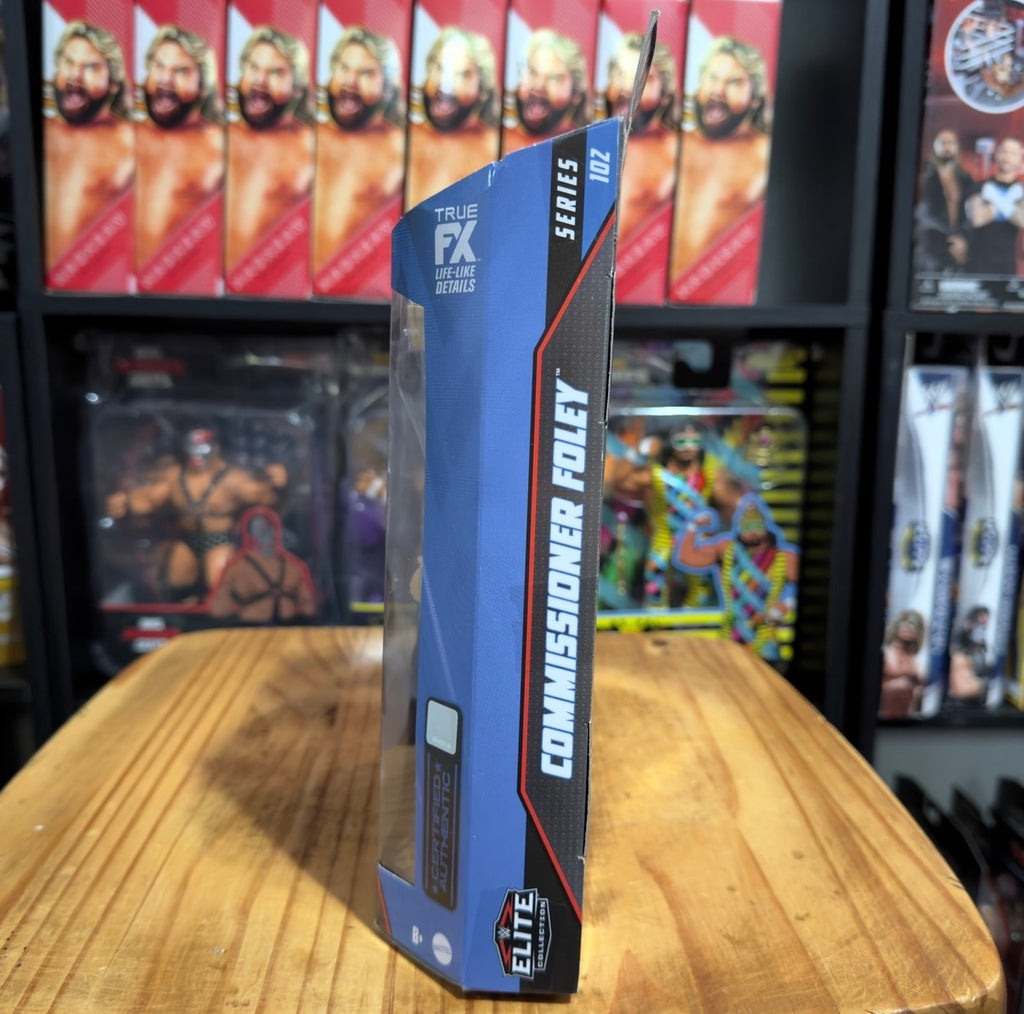 WWE Elite action figure box side with blue panel and Commissioner Foley Series 102 text