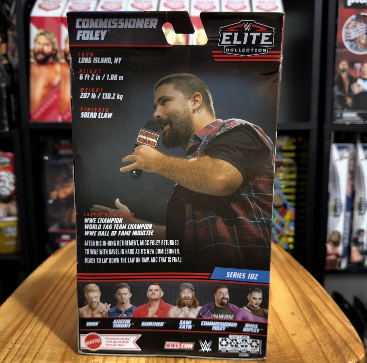 WWE Elite action figure packaging back with Commissioner Foley pose and Series 102 label