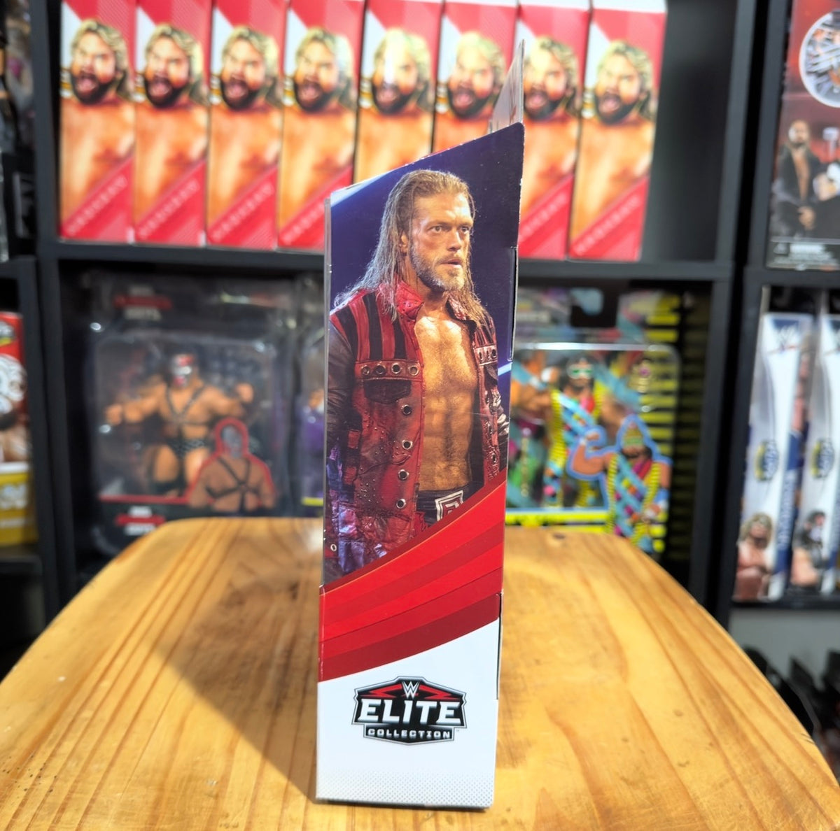 WWE Elite action figure box side panel with wrestler portrait and red stripe