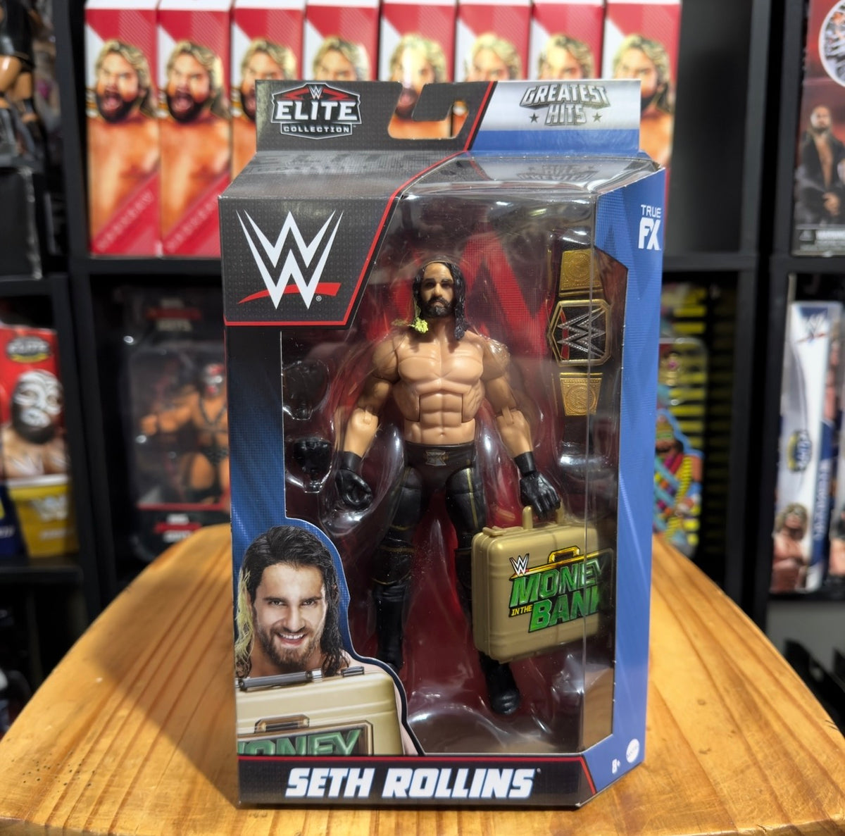 WWE Elite action figure in box showing Seth Rollins with championship bag