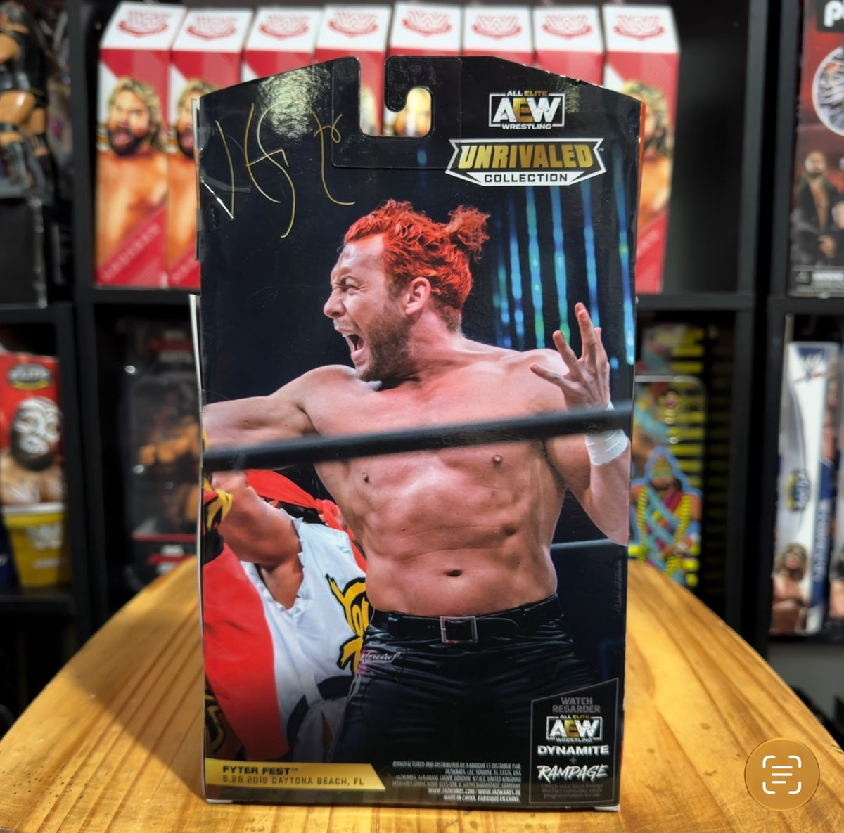 Action figure in box with Kenny Omega photo, AEW Unrivaled Collection logo