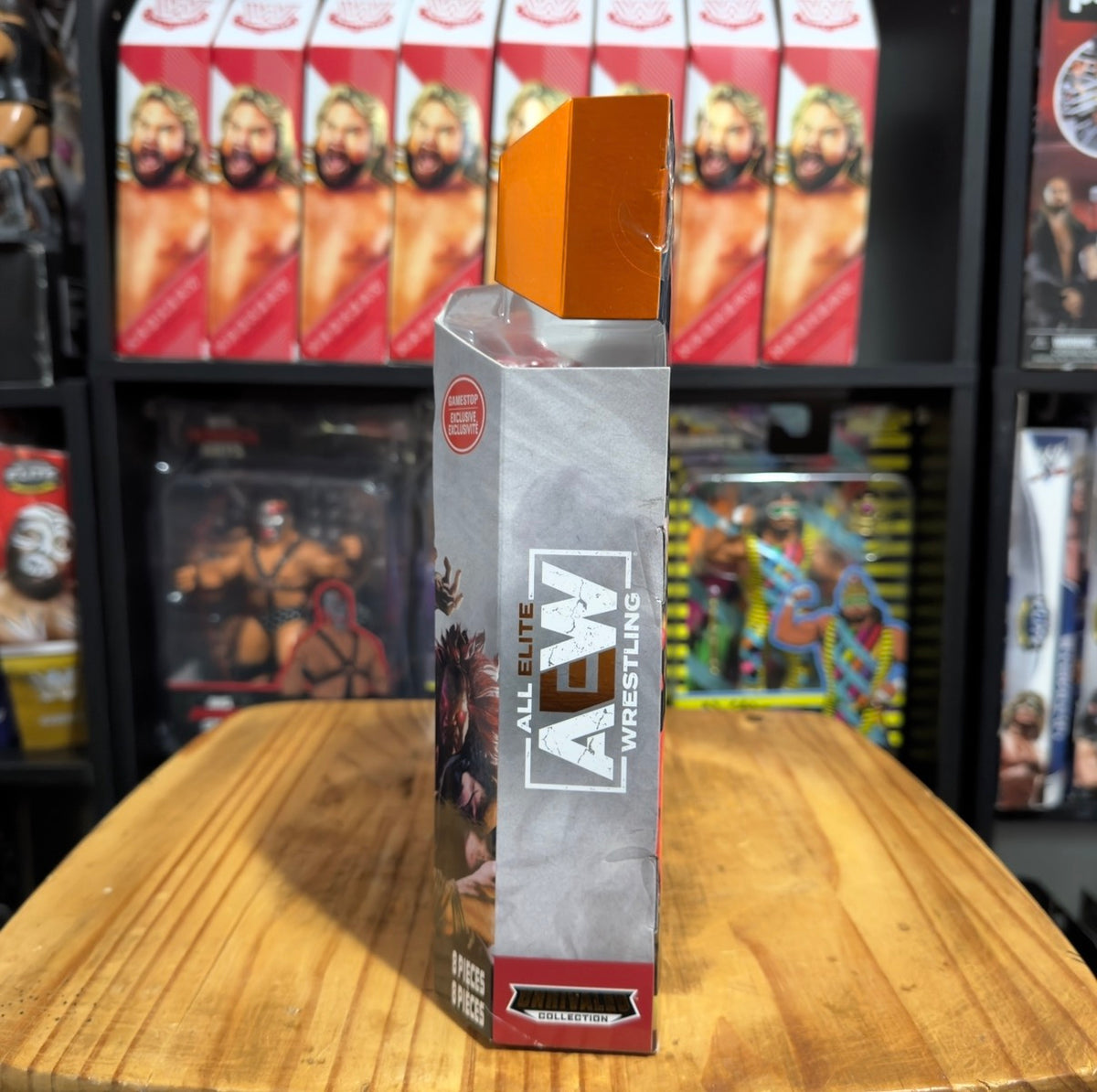 Action figure box side panel with AEW Elite Wrestling branding and gold top