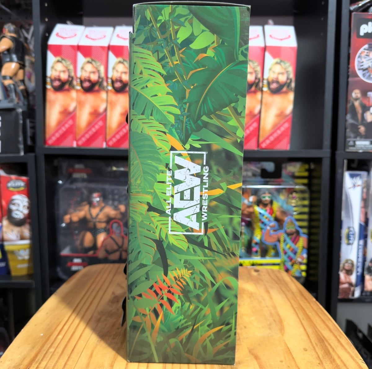 Green foliage Jurassic Express collectible box with vertical title text and AEW branding.